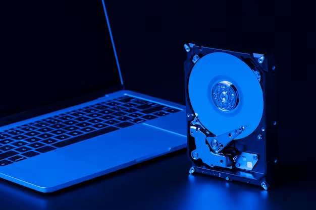 Hard drive with blue light and laptop